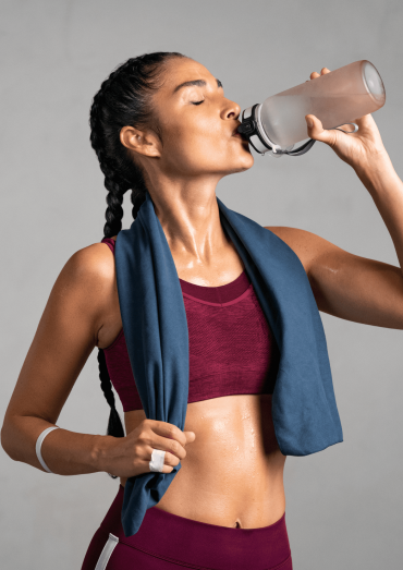 woman drink water after exercises